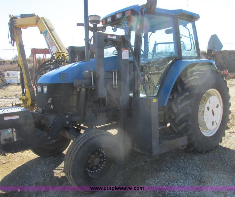 image for item L7087 1999 Ford New Holland TS110 tractor with side boom mower