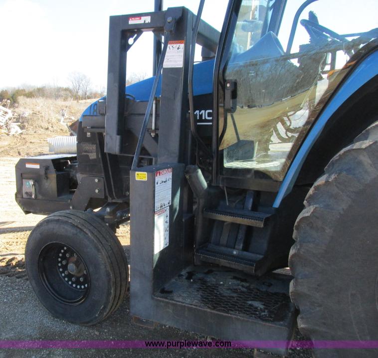 image for item L7087 1999 Ford New Holland TS110 tractor with side boom mower