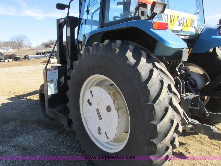 image for item L7087 1999 Ford New Holland TS110 tractor with side boom mower