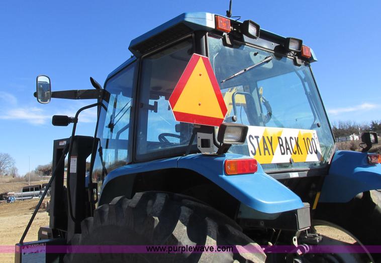 image for item L7087 1999 Ford New Holland TS110 tractor with side boom mower