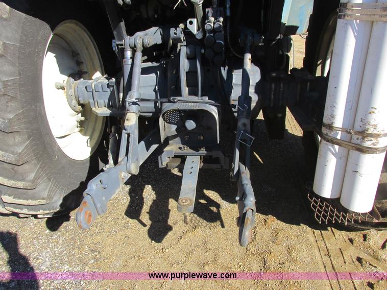 image for item L7087 1999 Ford New Holland TS110 tractor with side boom mower