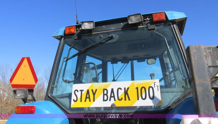 image for item L7087 1999 Ford New Holland TS110 tractor with side boom mower