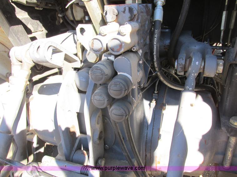 image for item L7087 1999 Ford New Holland TS110 tractor with side boom mower