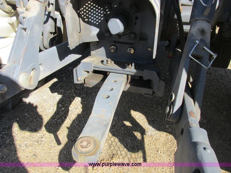 image for item L7087 1999 Ford New Holland TS110 tractor with side boom mower