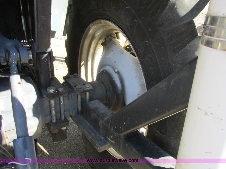 image for item L7087 1999 Ford New Holland TS110 tractor with side boom mower