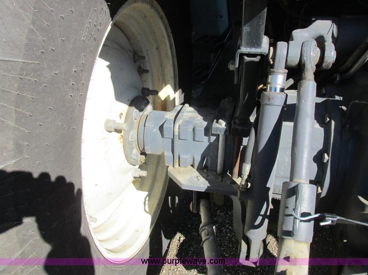 image for item L7087 1999 Ford New Holland TS110 tractor with side boom mower