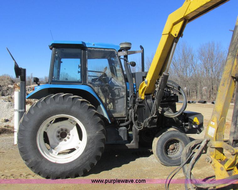image for item L7087 1999 Ford New Holland TS110 tractor with side boom mower