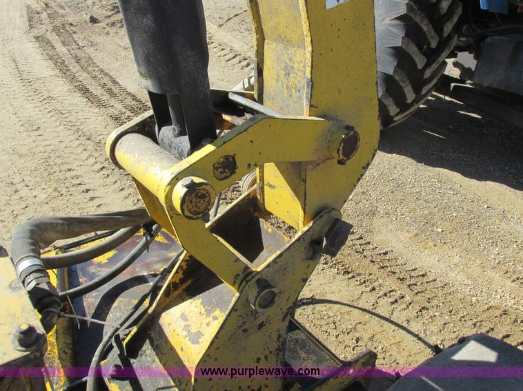 image for item L7087 1999 Ford New Holland TS110 tractor with side boom mower