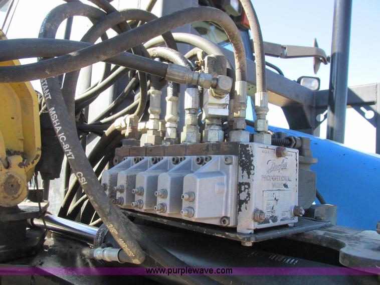 image for item L7087 1999 Ford New Holland TS110 tractor with side boom mower