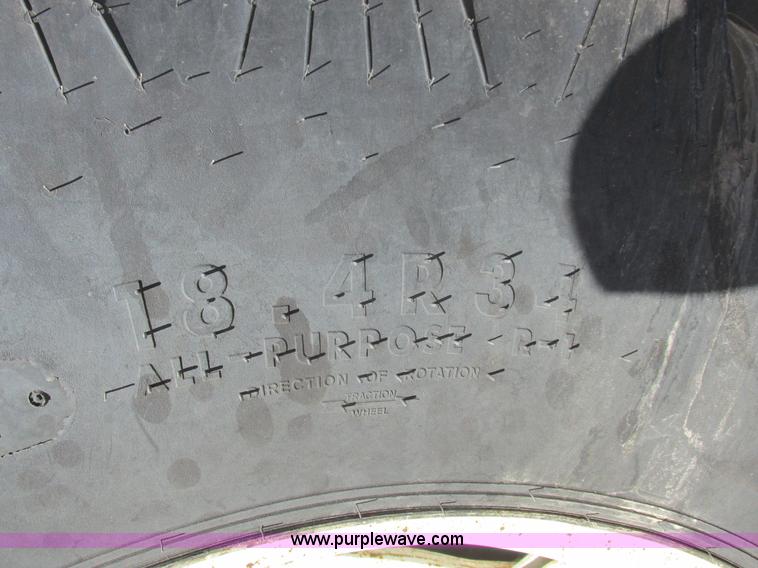 image for item L7087 1999 Ford New Holland TS110 tractor with side boom mower