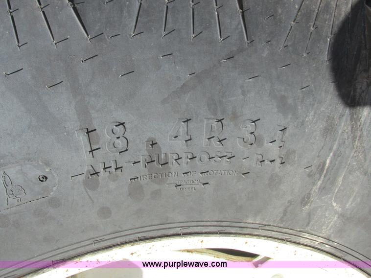 image for item L7087 1999 Ford New Holland TS110 tractor with side boom mower