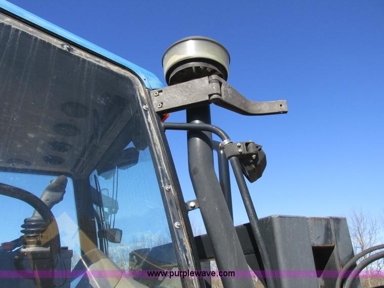 image for item L7087 1999 Ford New Holland TS110 tractor with side boom mower