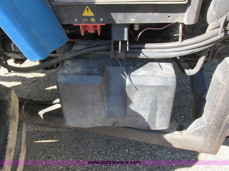 image for item L7087 1999 Ford New Holland TS110 tractor with side boom mower