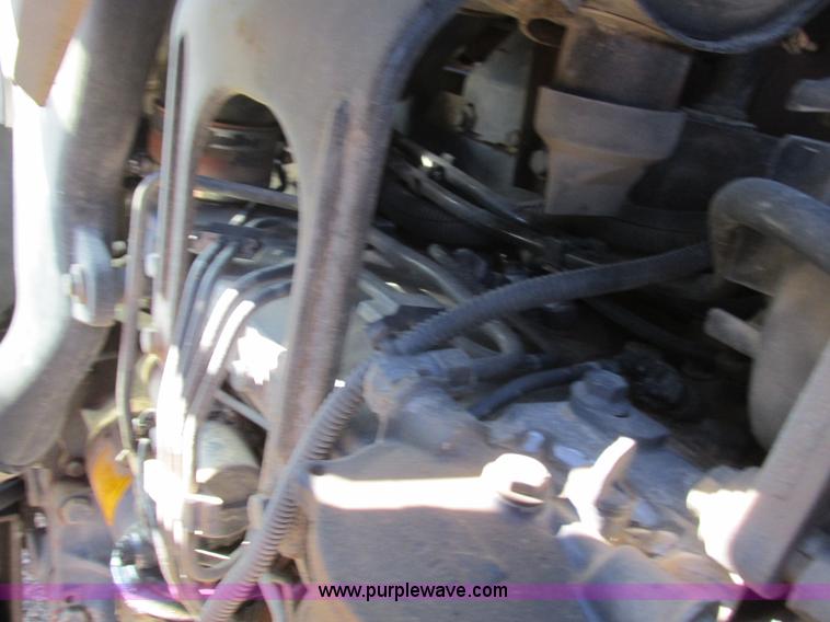 image for item L7087 1999 Ford New Holland TS110 tractor with side boom mower