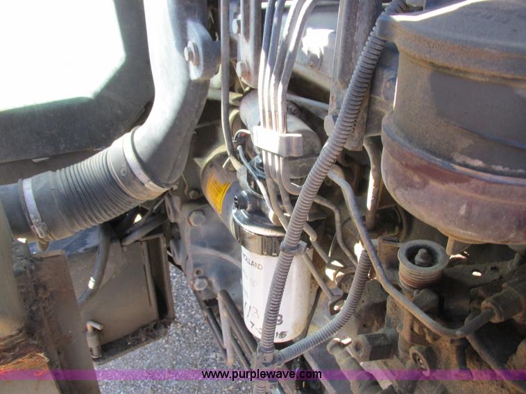 image for item L7087 1999 Ford New Holland TS110 tractor with side boom mower