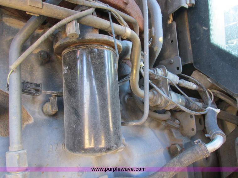 image for item L7087 1999 Ford New Holland TS110 tractor with side boom mower