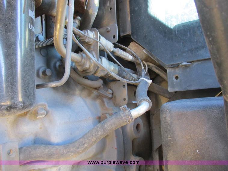 image for item L7087 1999 Ford New Holland TS110 tractor with side boom mower