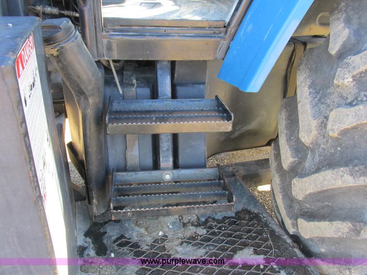 image for item L7087 1999 Ford New Holland TS110 tractor with side boom mower