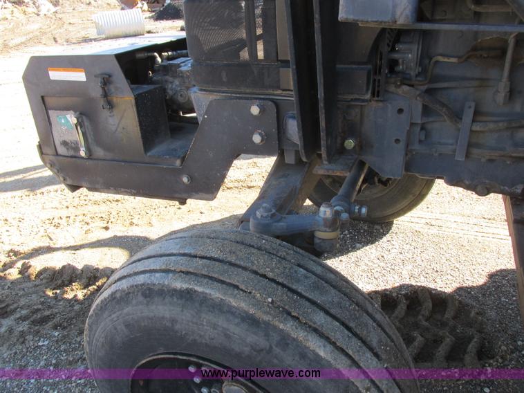 image for item L7087 1999 Ford New Holland TS110 tractor with side boom mower