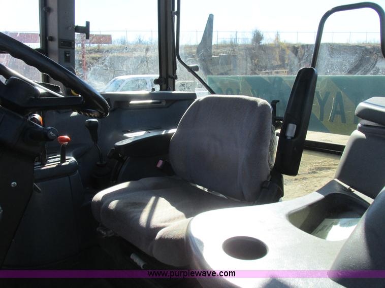 image for item L7087 1999 Ford New Holland TS110 tractor with side boom mower