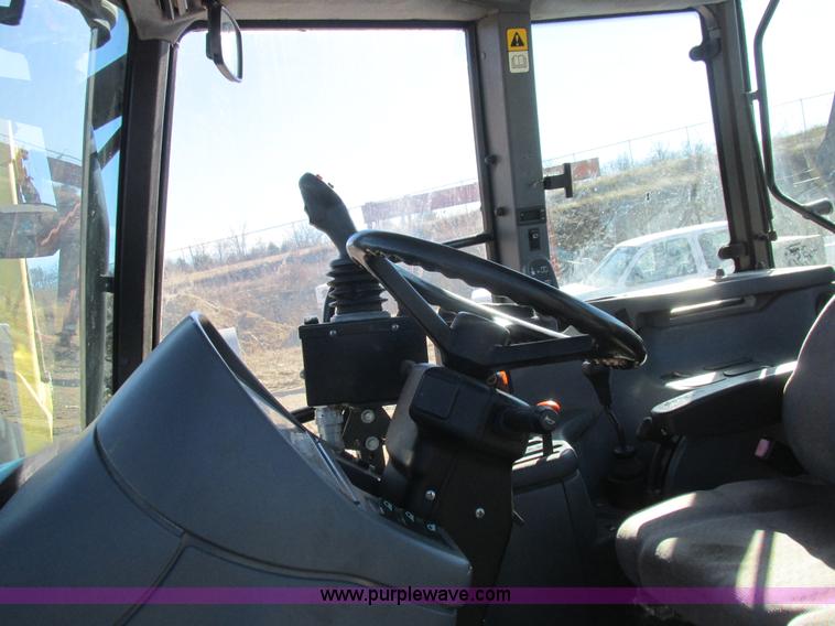 image for item L7087 1999 Ford New Holland TS110 tractor with side boom mower