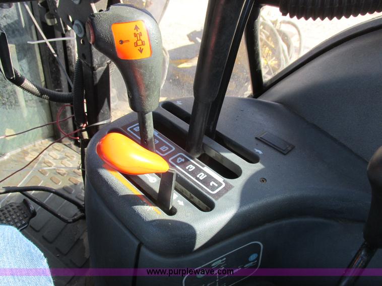 image for item L7087 1999 Ford New Holland TS110 tractor with side boom mower