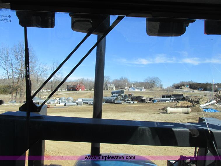 image for item L7087 1999 Ford New Holland TS110 tractor with side boom mower