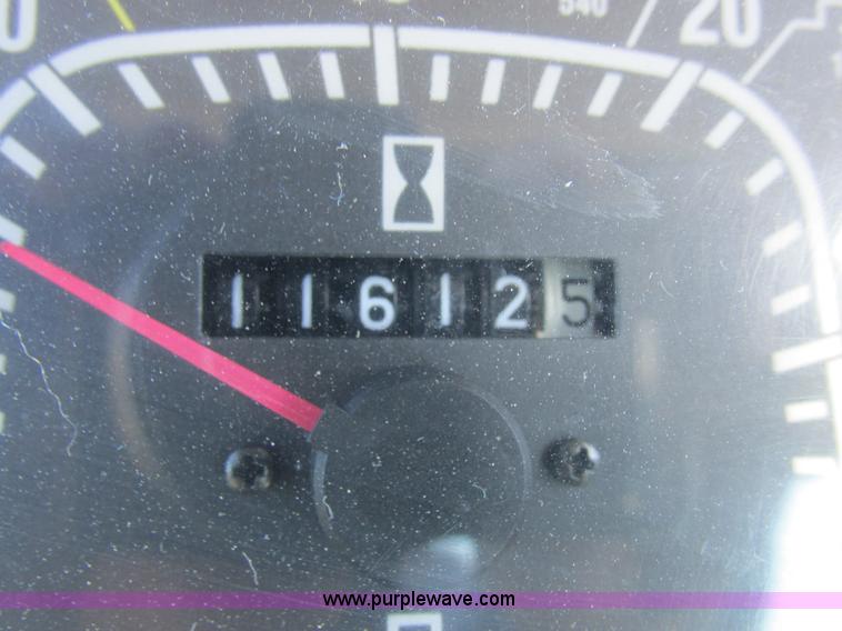 image for item L7087 1999 Ford New Holland TS110 tractor with side boom mower