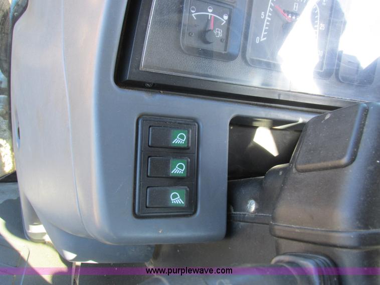 image for item L7087 1999 Ford New Holland TS110 tractor with side boom mower