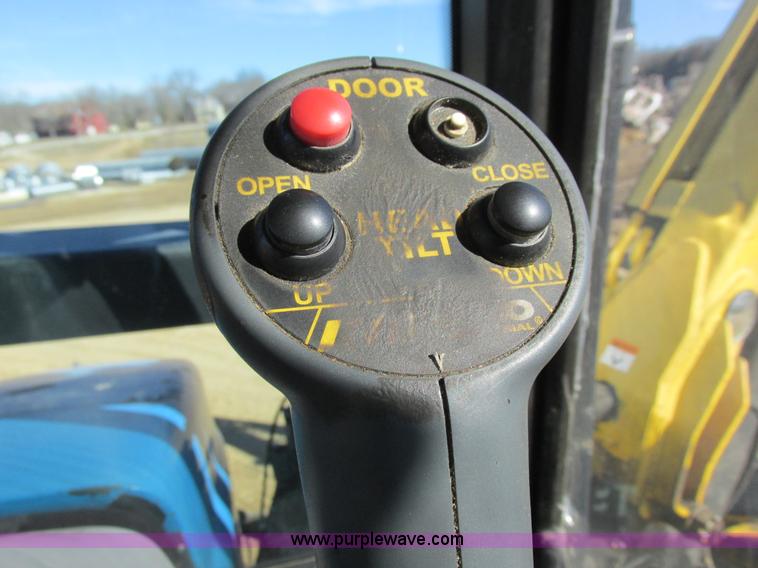 image for item L7087 1999 Ford New Holland TS110 tractor with side boom mower