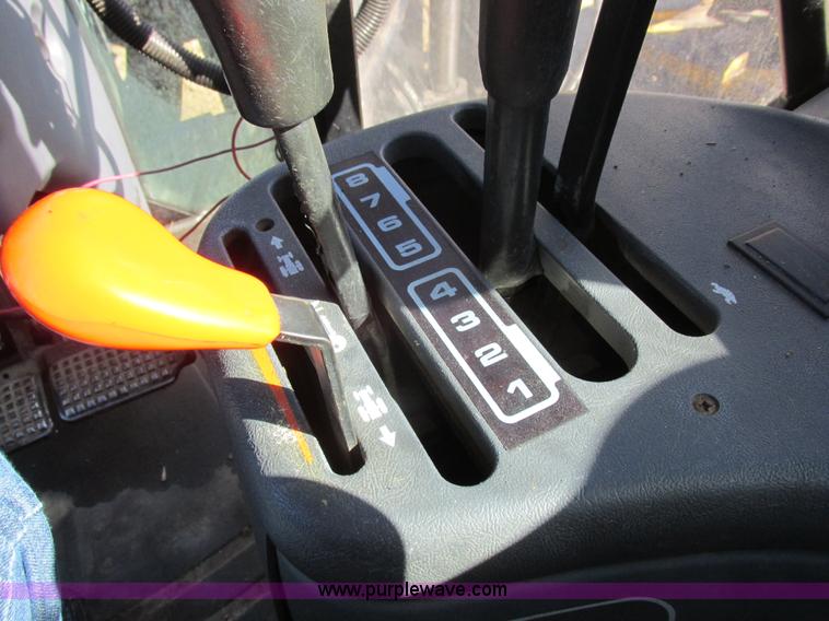 image for item L7087 1999 Ford New Holland TS110 tractor with side boom mower