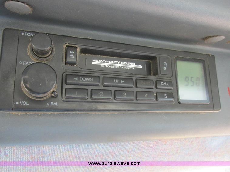 image for item L7087 1999 Ford New Holland TS110 tractor with side boom mower