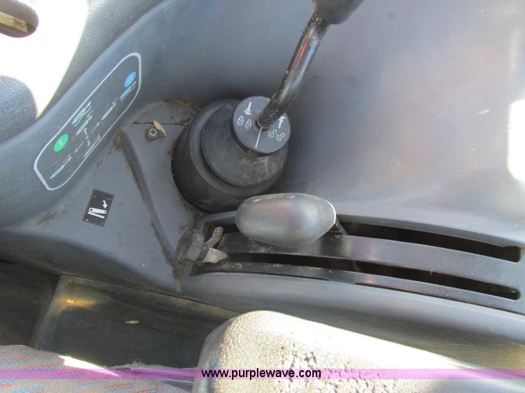 image for item L7087 1999 Ford New Holland TS110 tractor with side boom mower