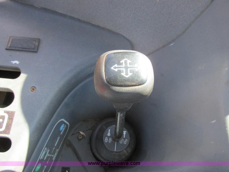 image for item L7087 1999 Ford New Holland TS110 tractor with side boom mower