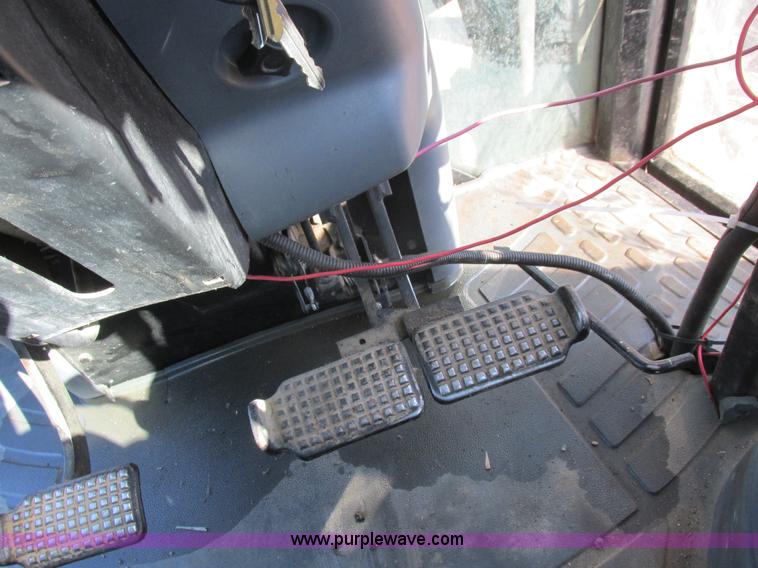 image for item L7087 1999 Ford New Holland TS110 tractor with side boom mower