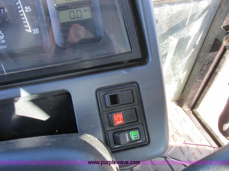 image for item L7087 1999 Ford New Holland TS110 tractor with side boom mower