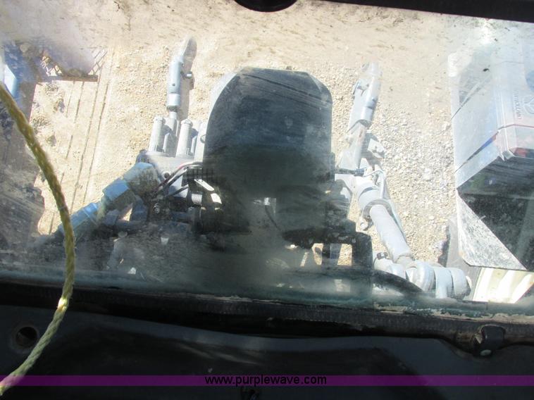 image for item L7087 1999 Ford New Holland TS110 tractor with side boom mower