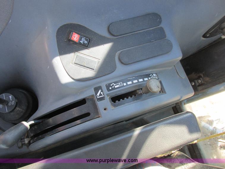 image for item L7087 1999 Ford New Holland TS110 tractor with side boom mower