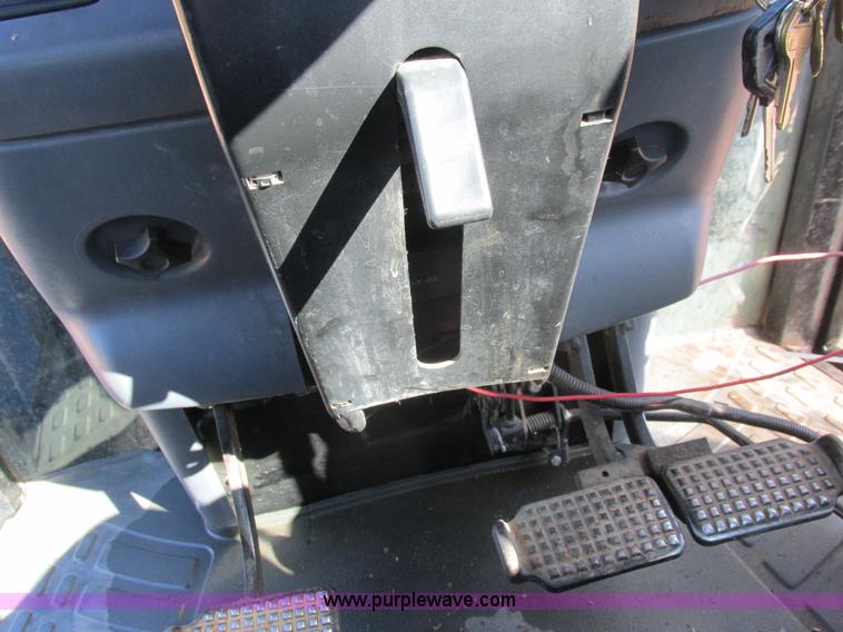 image for item L7087 1999 Ford New Holland TS110 tractor with side boom mower