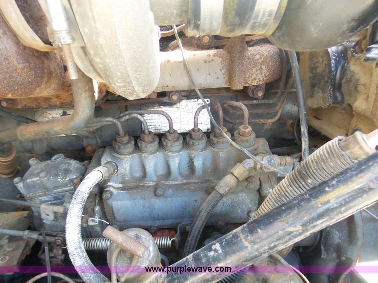 image for item L3209 1988 Mack DM690S roll off truck