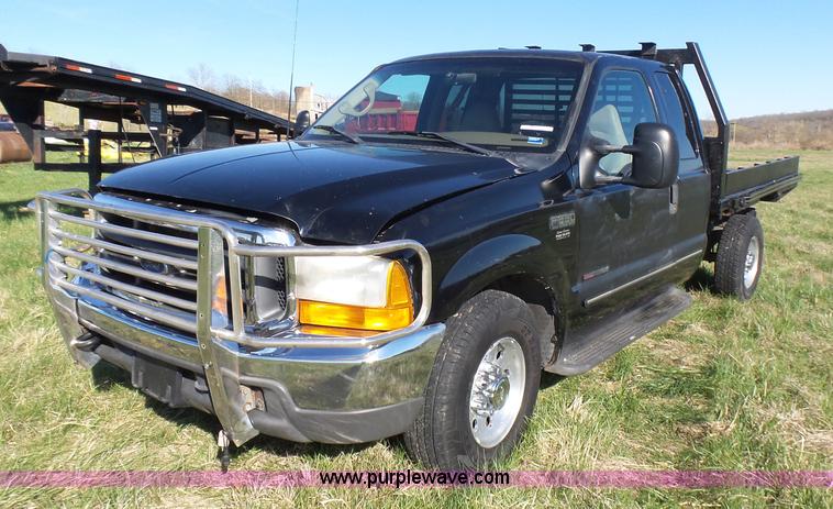 image for item BG9084 2000 Ford F250 Super Duty SuperCab flatbed pickup truck