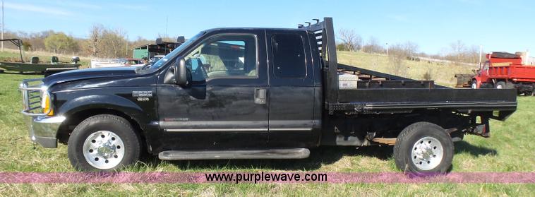 image for item BG9084 2000 Ford F250 Super Duty SuperCab flatbed pickup truck