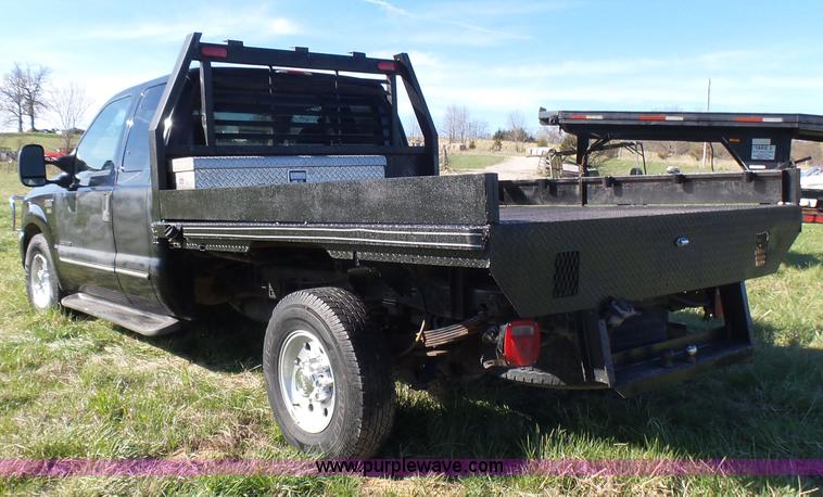 image for item BG9084 2000 Ford F250 Super Duty SuperCab flatbed pickup truck