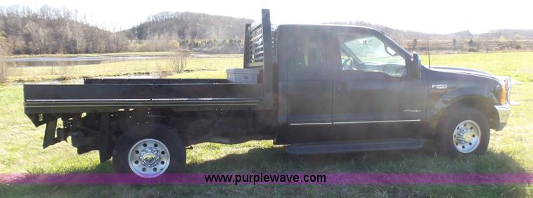 image for item BG9084 2000 Ford F250 Super Duty SuperCab flatbed pickup truck