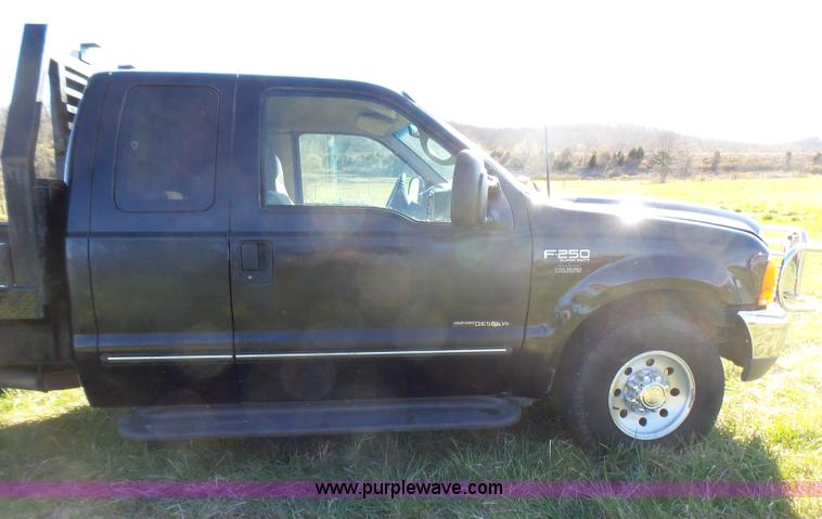 image for item BG9084 2000 Ford F250 Super Duty SuperCab flatbed pickup truck