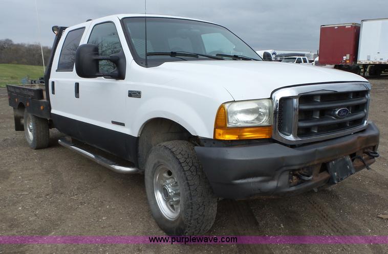 image for item L5690 1999 Ford F250 Super Duty XL Crew Cab flatbed pickup truck