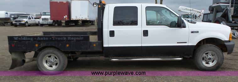 image for item L5690 1999 Ford F250 Super Duty XL Crew Cab flatbed pickup truck