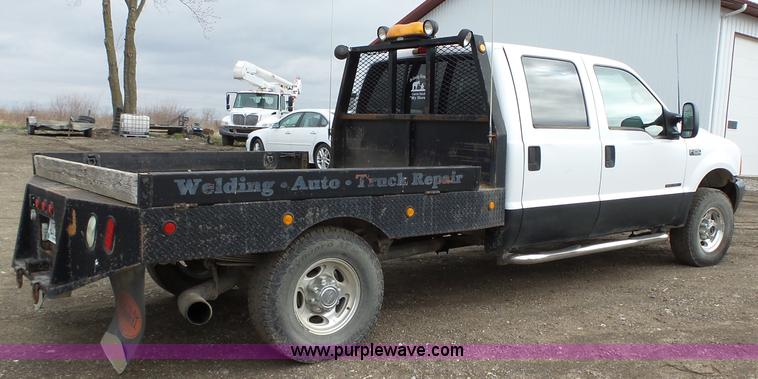 image for item L5690 1999 Ford F250 Super Duty XL Crew Cab flatbed pickup truck