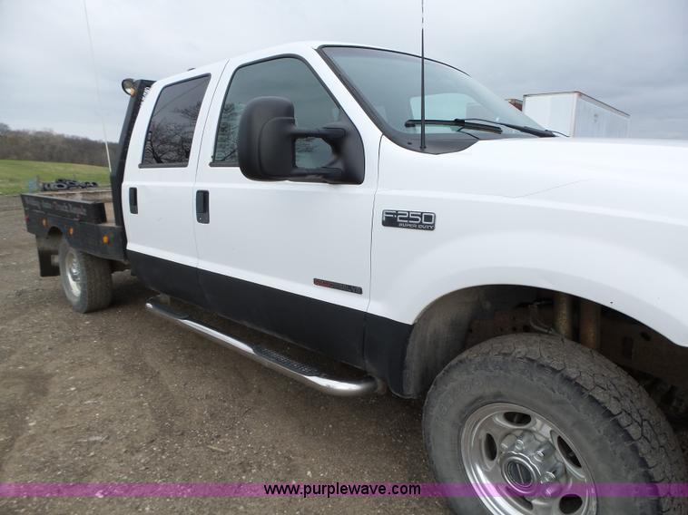 image for item L5690 1999 Ford F250 Super Duty XL Crew Cab flatbed pickup truck