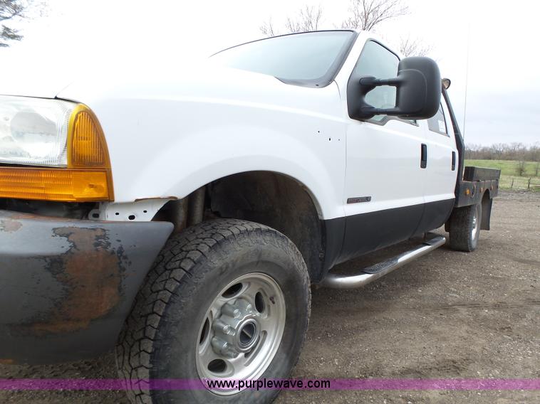 image for item L5690 1999 Ford F250 Super Duty XL Crew Cab flatbed pickup truck